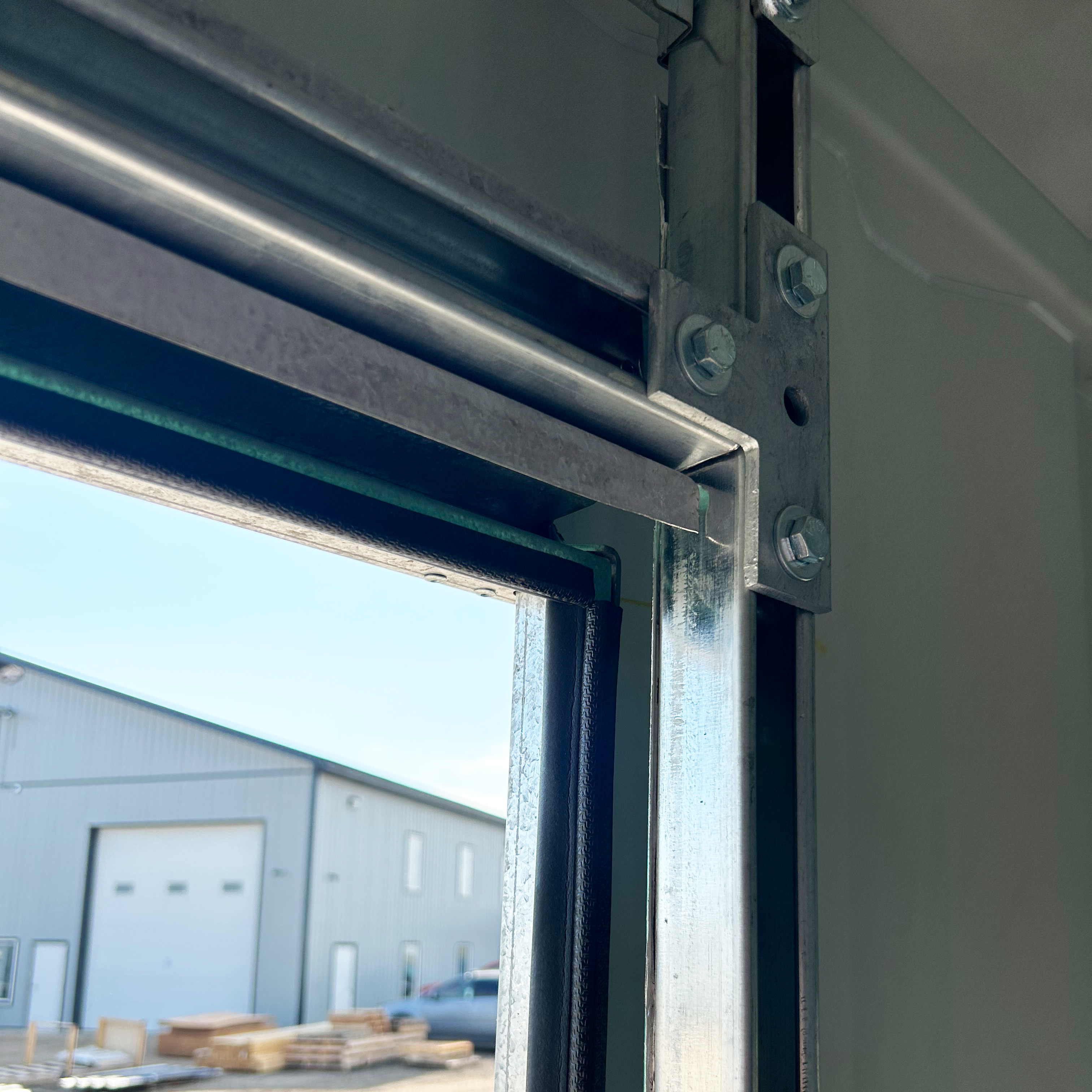 Inside view showing the galvanized steel door frame securely fastened to the shipping container’s interior corrugated wall