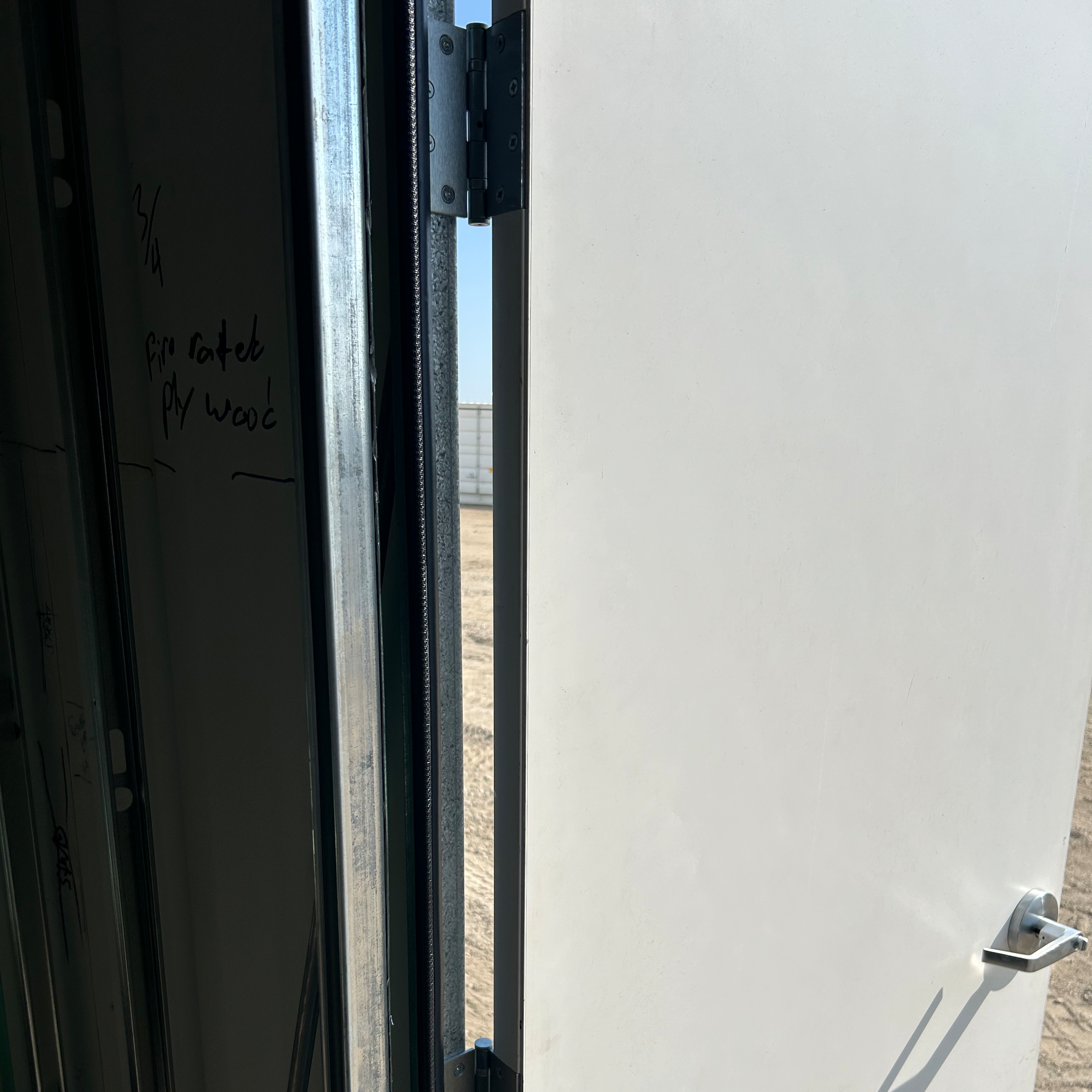 close up of hinges installed in frame attaching to the door